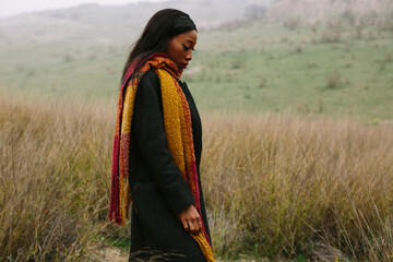 black woman with coat outdoors