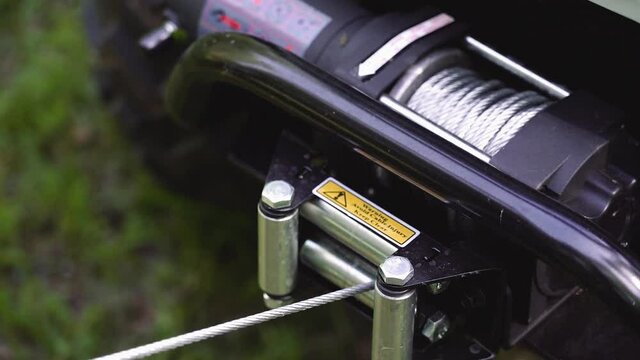 The winch is reeled off. ATV winch. Winch. Close up. 