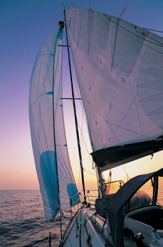 sailboat rigged with spinnaker and main sail sailing