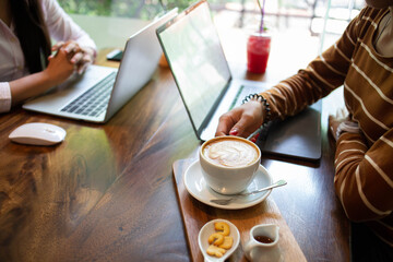 businesswoman hands searching for data on Notebook with analyzing charts at his workplace.concept