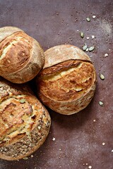 Homemade Freshly Baked Country Bread  made from wheat and whole grain flour on brown background. French Freshly baked bread. 