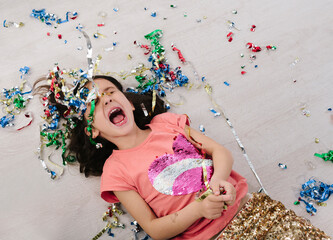 kid on floor with streamer laughing