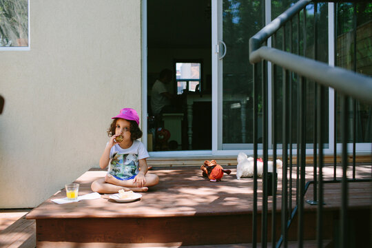 Kid eating breakfast in the porch
