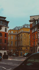 Fototapeta na wymiar Vertical photograph of buildings from the sidewalk on an afternoon in the City of London.