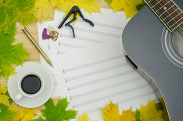 black guitar, autumn leaves and notes