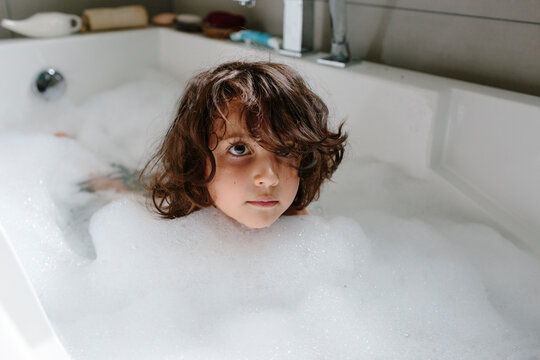 Kid having a foam bath