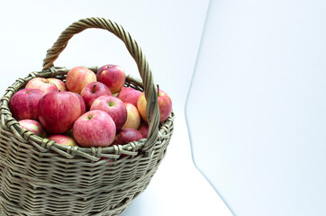 basket of willow twigs with ripe red apples