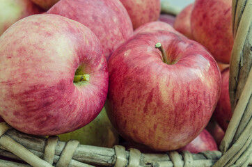 basket of willow twigs with ripe red apples