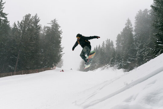 Man on the snowboard into the wild