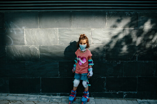 Kid on inline skates with mask looking at camera
