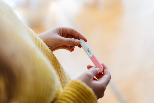 Anonymous woman holding a negative pregnancy test
