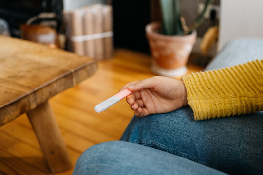 Concerned anonymous young woman waiting for the results of the pregnancy test