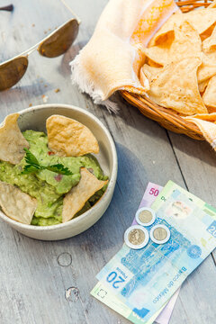 Nachos, guacamole and Mexican Pesos