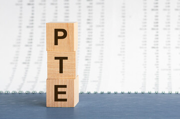 PTE - acronym from wooden blocks with letters, Pearson Tests of English PTE concept Foreign...