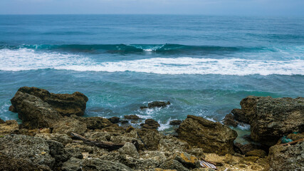 Fototapeta na wymiar Ocean wave rolling toward with marine rocks in coast of Taiwan island. Seascape