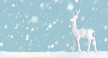 Scene of a deer in a snowy landscape with light blue background