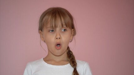 Surprised little girl. Isolate on pink background
