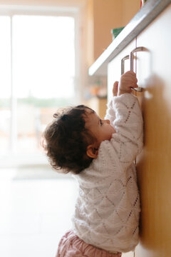 Baby trying to reach the kitchen counter