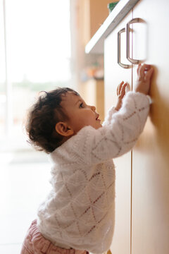 Baby trying to reach the kitchen counter