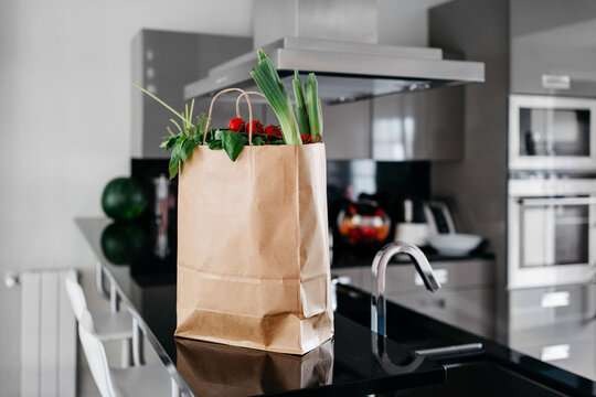 Paper bag of groceries on the kitchen counter