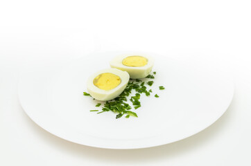 sliced ​​boiled egg and greens on a light background