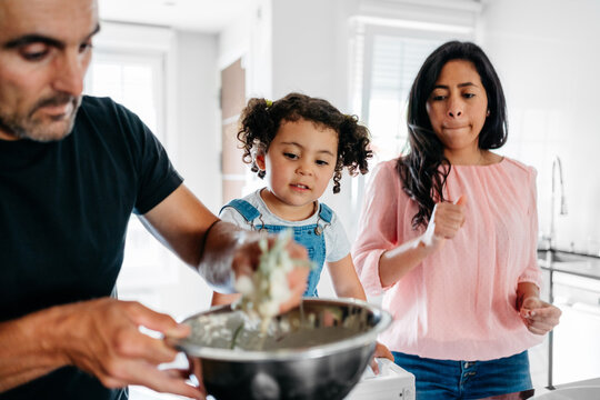 Happy family cooking vegan food at home