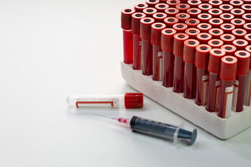 Injection syringe with blood sample vials at a medical laboratory