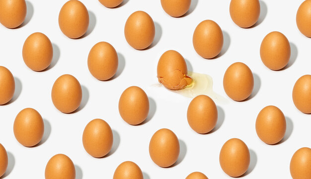 Seamless background of brown eggs placed in rows on white table in studio