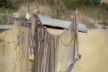 A fishing net is a net used for fishing. Nets are devices made from fibers woven in a grid-like structure. Some fishing nets are also called fish traps, for example fyke nets.