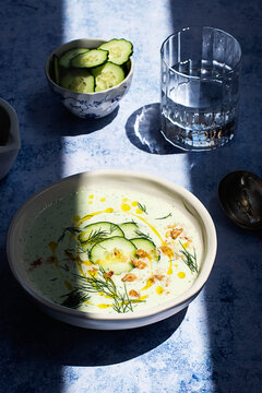 From above cold cucumber and dill soup named Tarator on rustic table with shadow