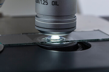 Distribution of immersion oil under light microscope objective lens. Oil immersion is a technique...