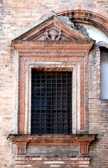 Window on the external wall of the Broletto of Lodi, house of the city council originally built in the 13th century, in Lodi, Lombardy region, northern Italy.