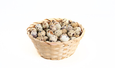 quail eggs inside the basket on white background