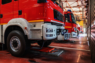 Fire trucks parked in fire brigade prepared for action.