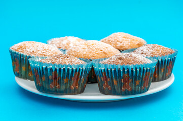 Plate with cupcakes on blue.