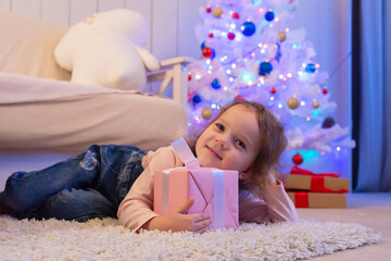 Little curly girl with gift, Christmas