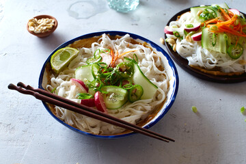 Vegan rice noodle salad made with fresh vegetables, lime and peanut sauce