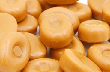 caramel candies on background
