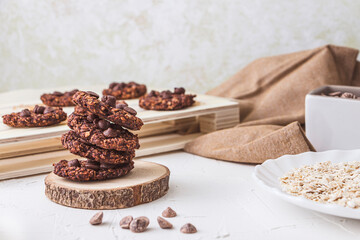 Still life shot of a stack of freshly oven baked oatmeal and banana chocolate chips over a wood trunk slice