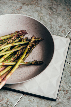 Raw Organic Asparagus Spears, on rustic surface