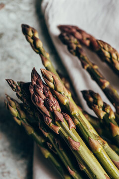 Raw Organic Asparagus Spears, on rustic surface