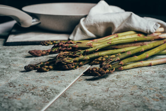 Raw Organic Asparagus Spears, on rustic surface