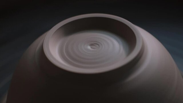 Handmade Cup of clay on the Twisted Pottery Wheel. Potter's work close-up. Potter rolls clay. Handmade.