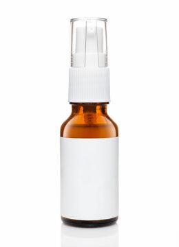 Dark cosmetic amber glass bottle with white label isolated on white background.