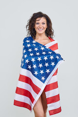 attractive girl posing with USA flag in studio on white background