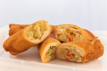Side dish of egg rolls sliced  shows the deep fried roll stuff with goodness.