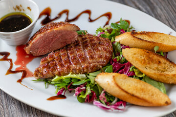 grilled duck breast with honey sauce and salad