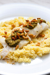 cod with green pesto and pine seeds with couscous