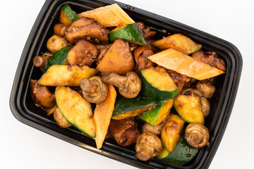 Overhead view of large bowl of mushroom chicken shows the sheen of sweet sauce and meat