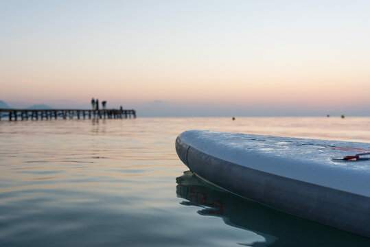 Paddleboard against spectacular sunset sky